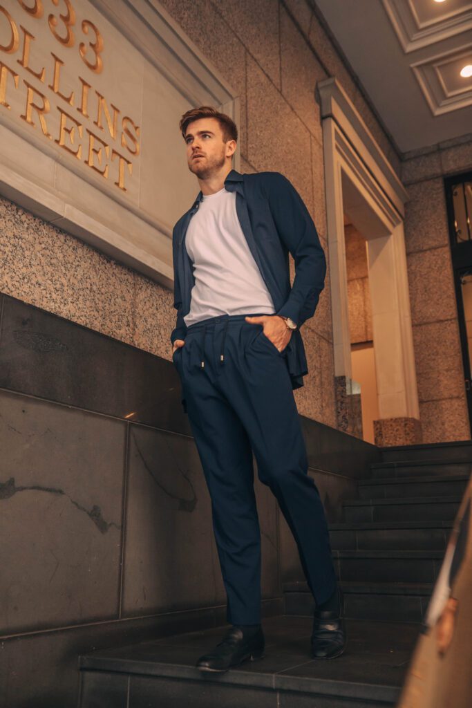 NOTA man in suit reading notebook, professional studio photo and model, in public in melbourne building