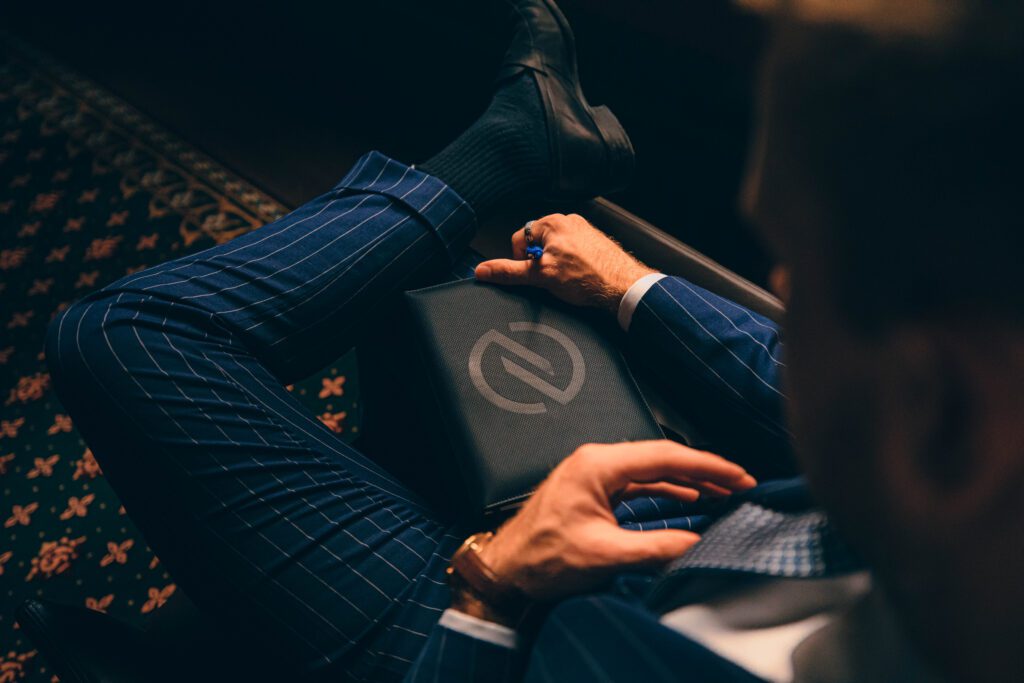 NOTA man in suit reading notebook, professional studio photo and model, in public in melbourne building