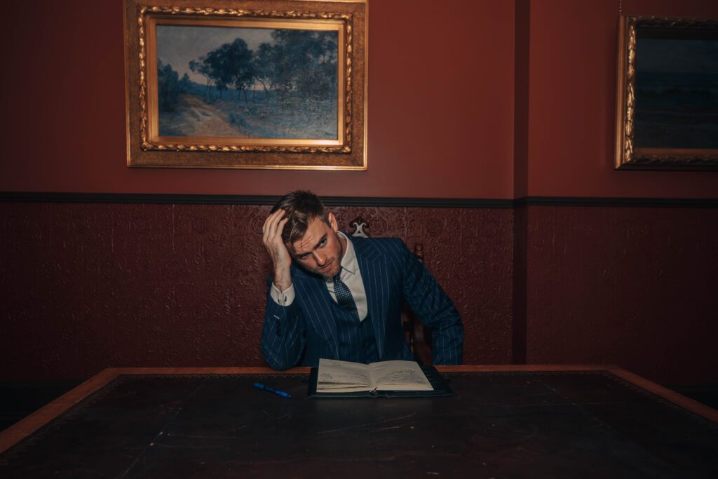 NOTA man in suit reading notebook, professional studio photo and model, in public in melbourne building