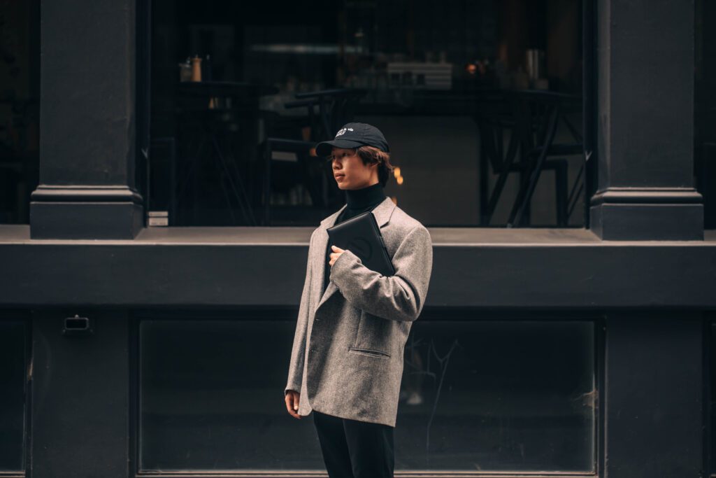 NOTA man in suit reading notebook, standing outside on melbourne street