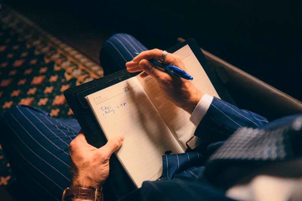 NOTA man in suit reading notebook, professional studio photo and model, in public in melbourne building