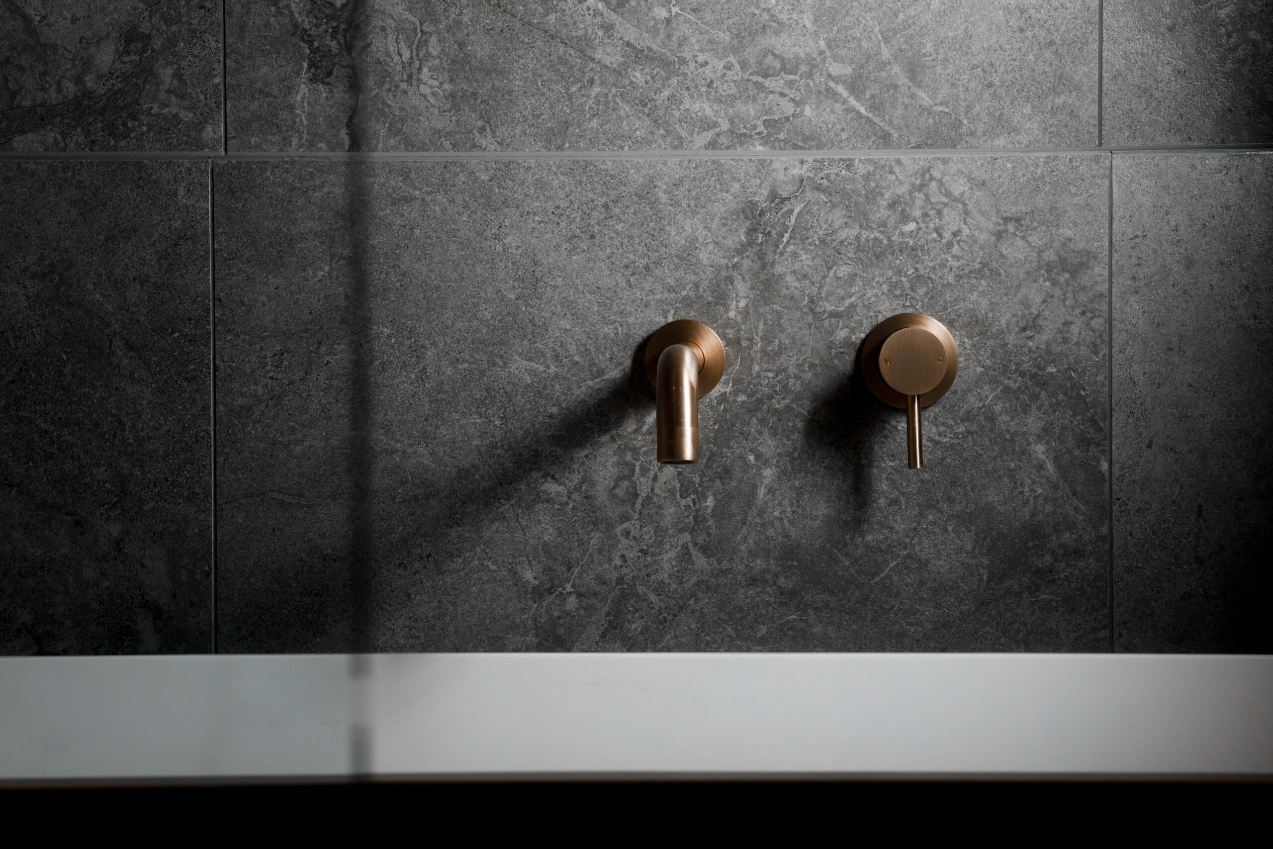 Par Taps, helen and joey estate, black tapware with professional studio photos, clothe hangers, ceiling shower head with wall mixer, concrete bathroom, bronze tapware, rose gold